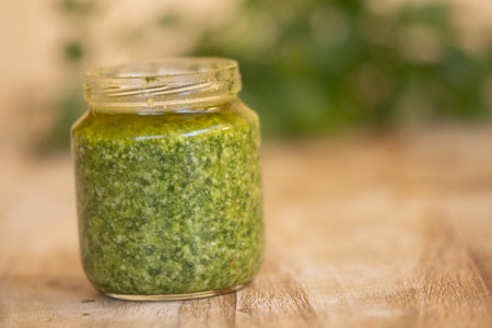 fresh homemade basil pesto in a glass jarの写真素材