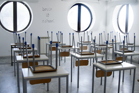 empty school classroom with the word september on the chair
