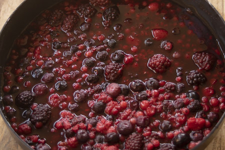berries cooked in their sauce in a panの写真素材