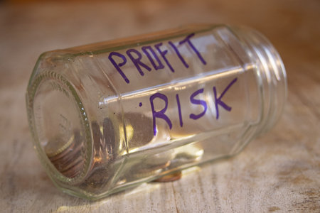 concept of profit risk with coins inside a glass jar and the word written on Itの写真素材