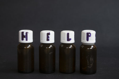 word help written with a marker on the caps of medicine bottlesの写真素材