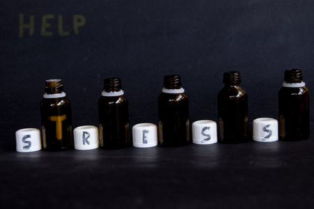 glass bottles with word stress written on the capsの写真素材