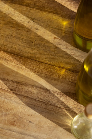 colored reflections and shadows of oil bottles on wooden backgroundの写真素材