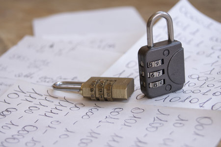 small pieces of paper with binary number sequences written on them with two combination locks on themの写真素材