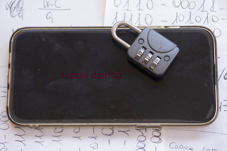 combination padlock rests on a smartphone screen, symbolizing digital data protection