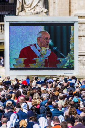 Rome, 13 April 2014: A group of believers, in St. Peter's Square on Palm Sunday during the Eucharistic blessing of Pope Francis. Pope Francis on the big screen. April 23, 2014, Vatican City, Italyのeditorial素材