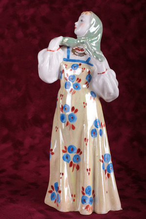 ceramic figurine of a girl in national dressesの写真素材