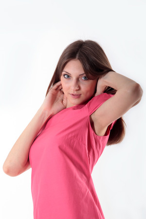 beautiful girl in pink dress looks into the lensの写真素材