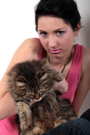 a young girl holding a fluffy catの写真素材