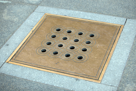 bronze square hatch in the Prague castleの写真素材
