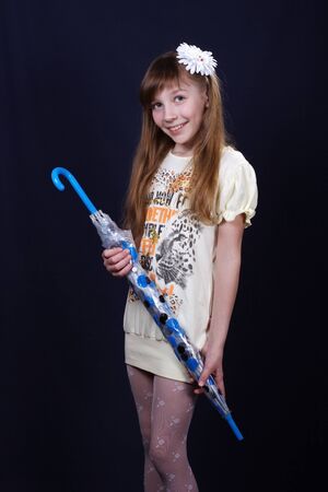 laughing girl with blue umbrellaの写真素材