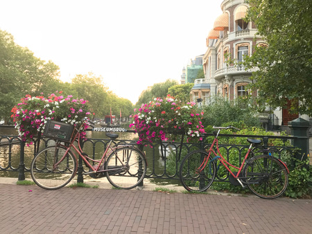 Bicycles Parked on a Bridge over a Canal at Sunset.のeditorial素材
