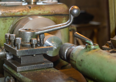 Vintage lathe machine in workshop. Selective focus with shallow depth of field.