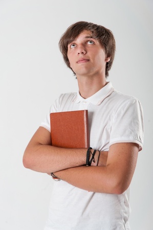 Young man with brown bookの写真素材