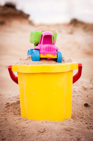 Toy dump-truck in the bucket with sand, summer, dayの写真素材
