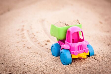 Toy dump-truck in the sands and its traceの写真素材