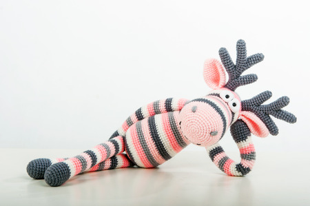 Soft toys lying elk on white backgroundの写真素材