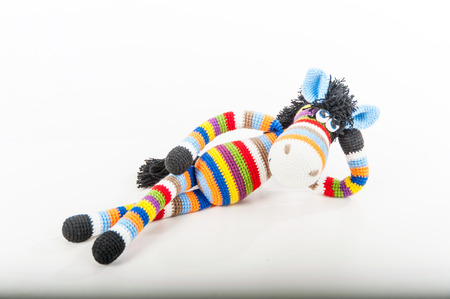 Soft toy lying bright zebra on white backgroundの写真素材