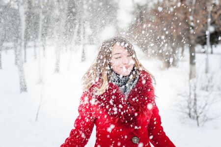 Winter portrait of young beautiful girl with snow.の写真素材