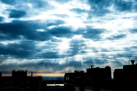 Blue dramatic sky with clouds and sunbeamsの写真素材
