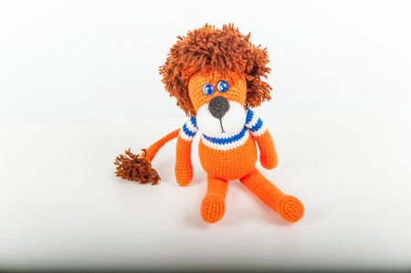 Soft toy orange lion on white backgroundの写真素材