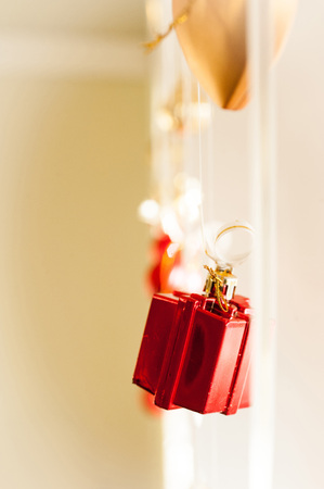 Christmas decoration, bright red box on ribbonの写真素材