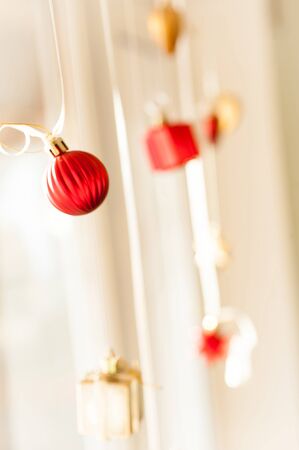 Christmas decoration, bright red balls on ribbonの写真素材