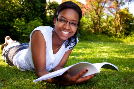 Young Student reading books at the school parkの写真素材