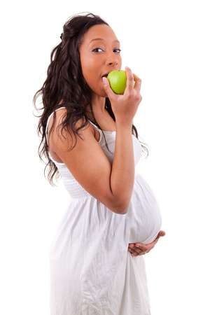 pregnant black woman eating an appleの写真素材