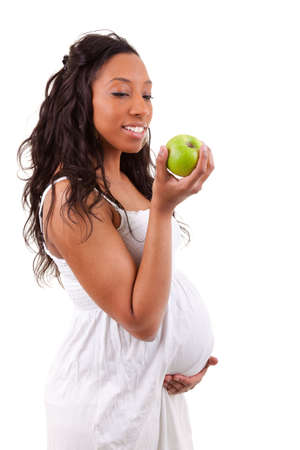 pregnant black woman eating an appleの写真素材