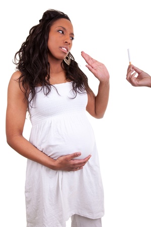 pregnant african american woman refusing a cigaretteの写真素材