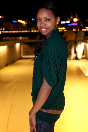 Portrait of young african american woman in city at night.の写真素材