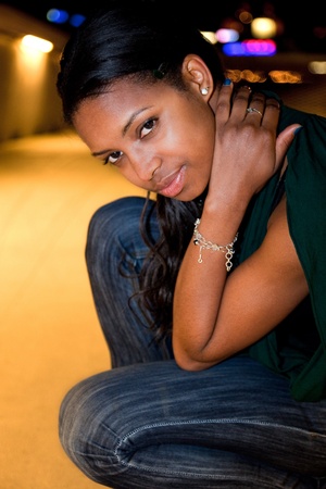 Portrait of young african american woman in city at night.の写真素材