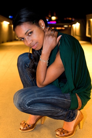 Portrait of young african american woman in city at night.の写真素材