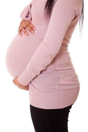 Beautiful pregnant black woman touching her bellyの写真素材