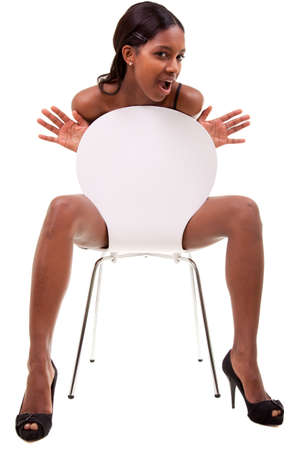 Sexy young african american woman posing in chair, isolated on white backgroundの写真素材