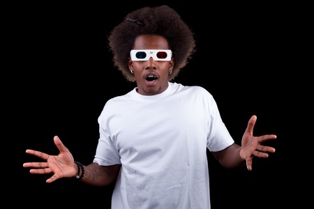 Young black man watching a 3D movie with retro 3D glassesの写真素材