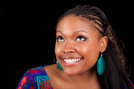 Portrait of a young beautiful black woman looking upの写真素材