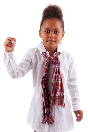 Adorable little African Asian girl holding a pen, isolated on white backgroundの写真素材