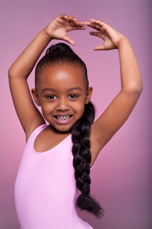Portrait of a cute little African American girl dancingの写真素材