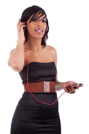 Young beautiful black woman in black dress listening to music, isolated on white backgroundの写真素材