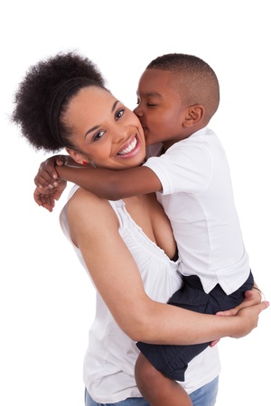 Little black boy kissing her mother, isolated on white backgroundの写真素材