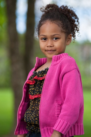 Outdoor portrait  of a cute little African Asian girlの写真素材
