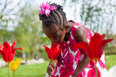 Portrait of a cute little african american girl playing in the gardenの写真素材