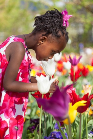 Portrait of a cute little african american girl playing in the gardenの写真素材