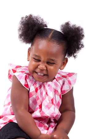 Cute little african american girl laughing, isolated on white backgroundの写真素材