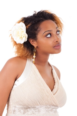 Young beautiful african american woman looking up, isolated on white backgroundの写真素材