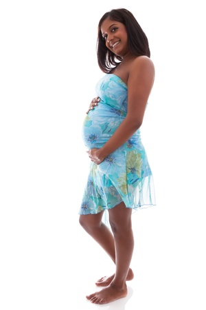 Young beautiful pregnant indian woman touching her bellyの写真素材