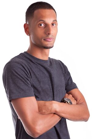 Portrait of a young african american man with folded arms, isolated on white backgroundの写真素材