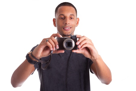 Portrait of a young african american man holding and taking a picture, isolated on white backgroundの写真素材